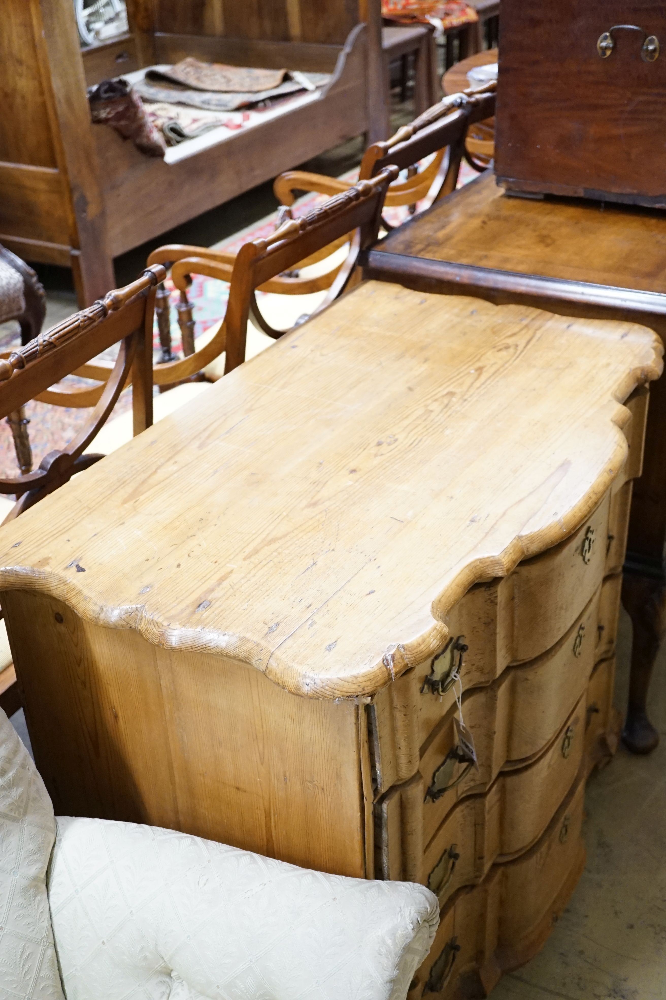 A 19th century Dutch pine Cupid’s bow shaped chest fitted four drawers, width 92cm, height 80cm